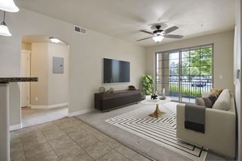 A living room with a flat screen tv and a large window.